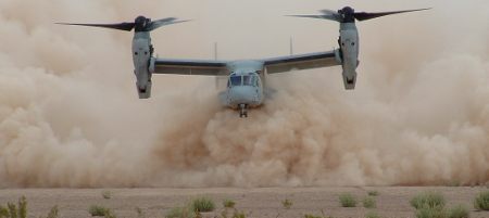 Image: A Boeing V-22 Osprey near the ground showing the dust cloud from rotor downwash which can lead to brownout conditions.